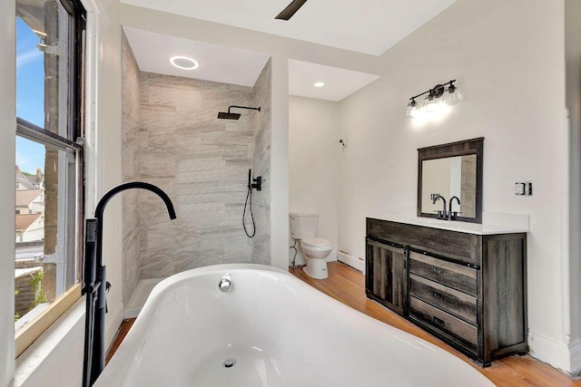 274 Ward Ave, Bellevue, KY 41073 - bathroom with a soaking tub, toilet, vanity, baseboard heating, and wood finished floors