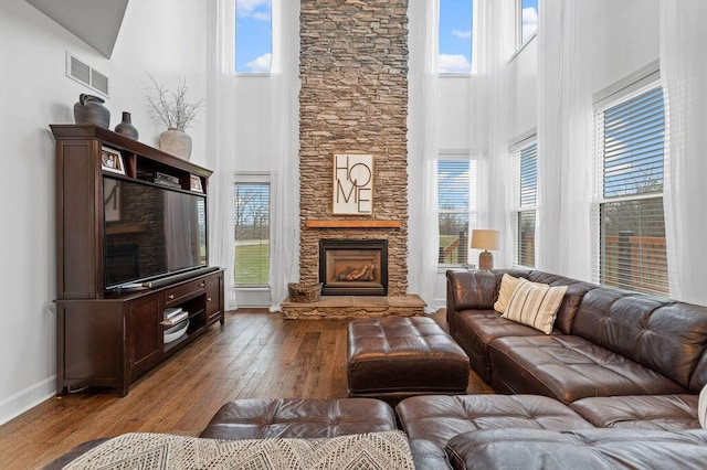 4800 Brewer Ln, Petersburg, KY 41080 - living area with a towering ceiling, a stone fireplace, healthy amount of natural light, and baseboards
