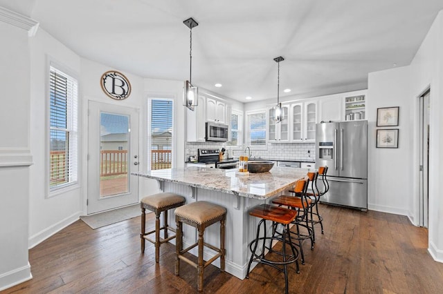 4800 Brewer Ln, Petersburg, KY 41080 - kitchen with appliances with stainless steel finishes, glass insert cabinets, white cabinetry, light stone countertops, and backsplash