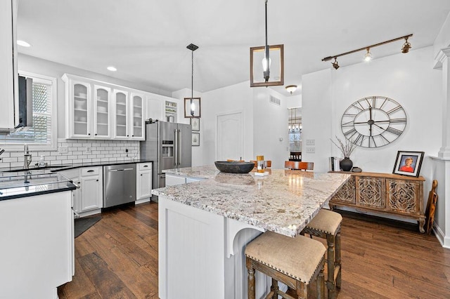 4800 Brewer Ln, Petersburg, KY 41080 - kitchen featuring stainless steel appliances, dark wood finished floors, a kitchen island, a kitchen bar, and white cabinetry