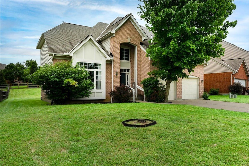 11332 Sheffield Ln, Walton, KY 41094 - traditional-style house featuring driveway, brick siding, a front lawn, and a shingled roof
