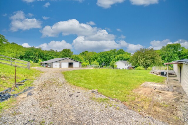 12085 Dickerson Rd, Walton, KY 41094 - view of yard featuring a garage, a pole building, an outbuilding, and a forest view