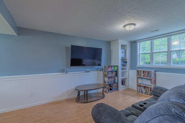 2780 Berwood Ln, Hebron, KY 41048 - living area with wood finished floors, wainscoting, and a textured ceiling