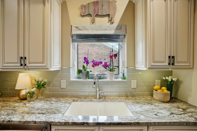2642 Sterling Trce, Burlington, KY 41005 - kitchen view of a sink, tasteful backsplash, cream cabinetry, and light stone countertops
