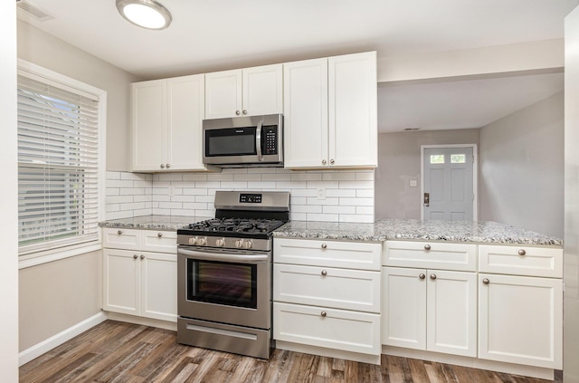 2530 Avon Dr, Crescent Park, KY 41017 - kitchen featuring stainless steel appliances, decorative backsplash, and white cabinets