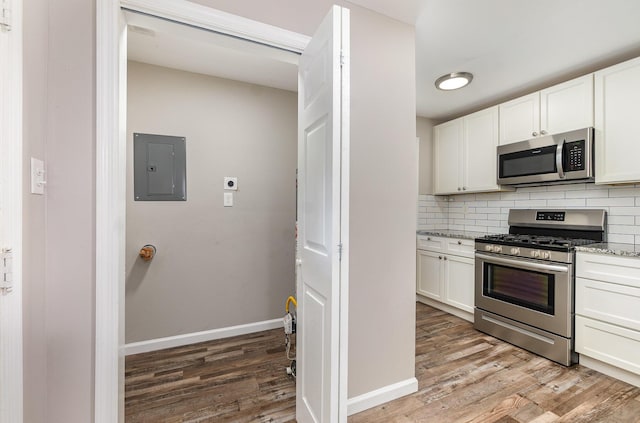 2530 Avon Dr, Crescent Park, KY 41017 - kitchen featuring stainless steel appliances, electric panel, light wood-type flooring, and light stone counters