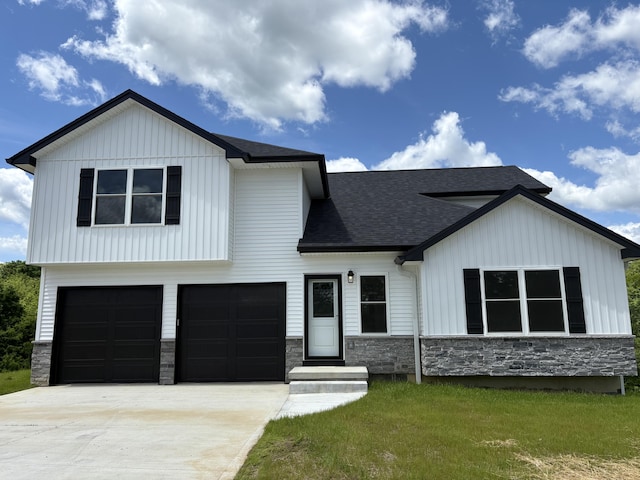 160 Saddlebrook Ln, Dry Ridge, KY 41035 - view of front facade with stone siding, a garage, a shingled roof, and board and batten siding