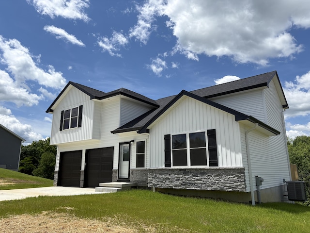 160 Saddlebrook Ln, Dry Ridge, KY 41035 - modern farmhouse featuring an attached garage, stone siding, board and batten siding, central air condition unit, and concrete driveway