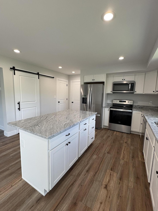 160 Saddlebrook Ln, Dry Ridge, KY 41035 - kitchen featuring appliances with stainless steel finishes, a barn door, dark wood-style floors, a center island, and recessed lighting