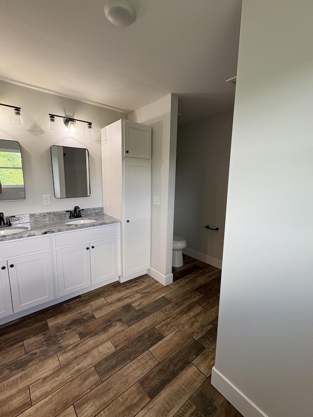 160 Saddlebrook Ln, Dry Ridge, KY 41035 - bathroom with double vanity, wood finished floors, toilet, and baseboards
