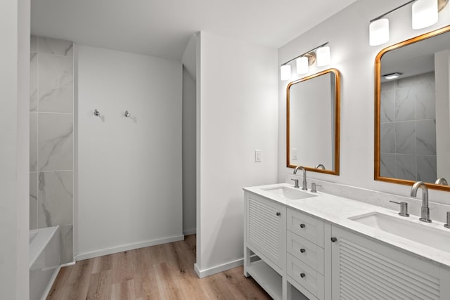 904 5th Ave, Dayton, KY 41074 - bathroom with double vanity, wood finished floors, baseboards, and washtub / shower combination