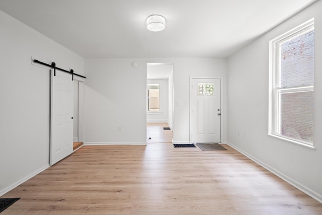 904 5th Ave, Dayton, KY 41074 - foyer entrance featuring a barn door, light wood-style flooring, and baseboards