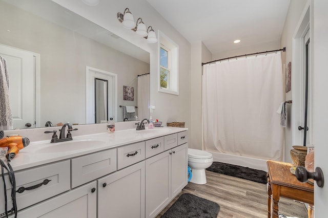 1500 Heathen Ridge Rd, Crittenden, KY 41030 - full bathroom featuring double vanity, toilet, wood finished floors, recessed lighting, and shower / bathtub combination with curtain