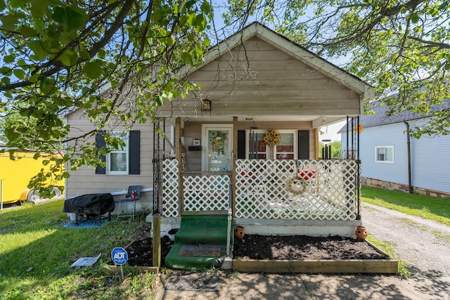 29 Locust St, Walton, KY 41094 - shotgun-style home with a porch, a front lawn, and driveway