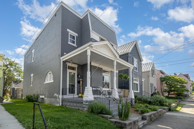 259 Van Voast Ave Unit 1, Bellevue, KY 41073 - modern home with covered porch, brick siding, a front yard, and metal roof