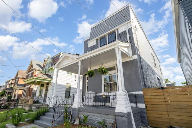 259 Van Voast Ave Unit 1, Bellevue, KY 41073 - view of front of house featuring covered porch and brick siding