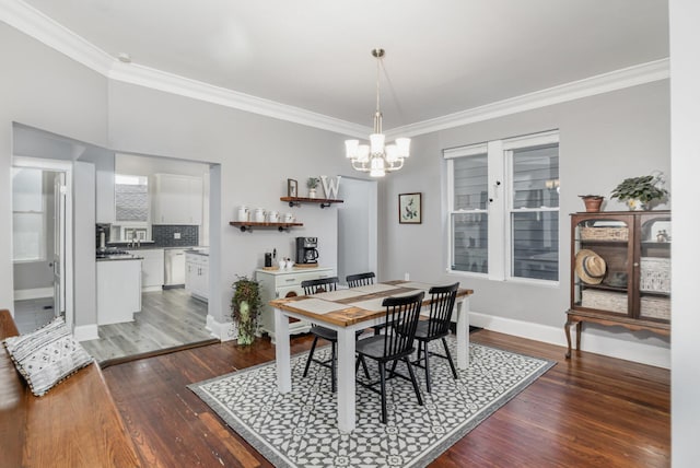 259 Van Voast Ave Unit 1, Bellevue, KY 41073 - dining space featuring crown molding, a chandelier, dark wood-style flooring, and baseboards