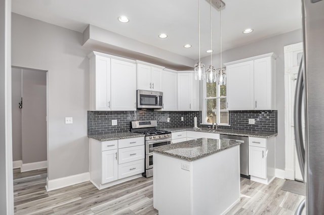 259 Van Voast Ave Unit 1, Bellevue, KY 41073 - kitchen with appliances with stainless steel finishes, light wood-style flooring, tasteful backsplash, and recessed lighting
