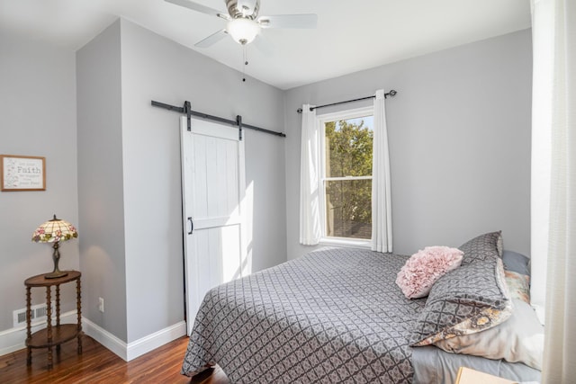259 Van Voast Ave Unit 1, Bellevue, KY 41073 - bedroom featuring a barn door, wood finished floors, baseboards, and a ceiling fan