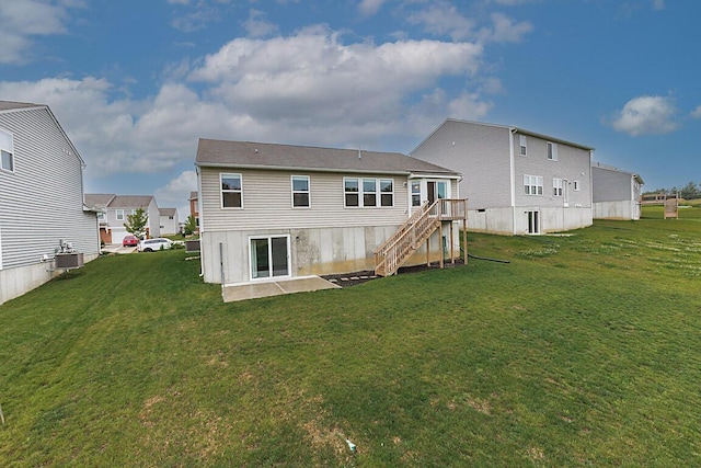 2345 John James Ct, Hebron, KY 41048 - rear view of house with stairs, a lawn, central air condition unit, and a deck