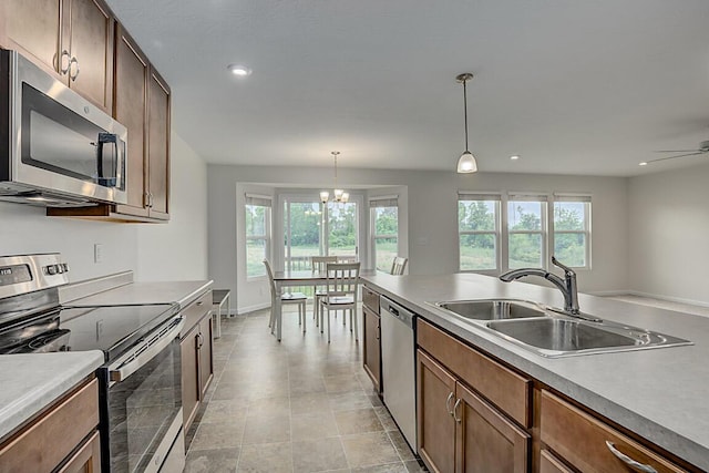 2345 John James Ct, Hebron, KY 41048 - kitchen featuring appliances with stainless steel finishes, a sink, healthy amount of natural light, pendant lighting, and recessed lighting