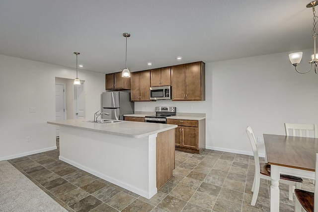 2345 John James Ct, Hebron, KY 41048 - kitchen featuring appliances with stainless steel finishes, a sink, baseboards, light countertops, and stone finish floors
