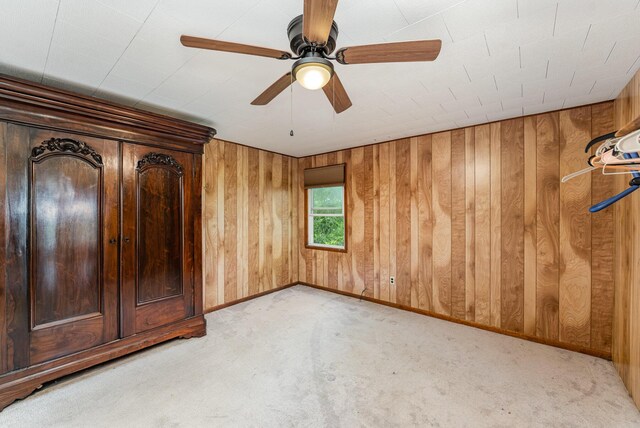 5489 Bridgeville Rd, Brooksville, KY 41004 - unfurnished bedroom featuring light carpet, wood walls, baseboards, and a ceiling fan