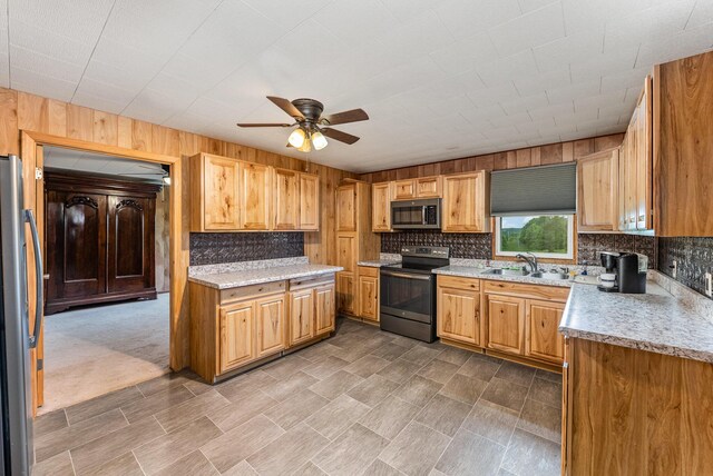 5489 Bridgeville Rd, Brooksville, KY 41004 - kitchen with appliances with stainless steel finishes, a ceiling fan, a sink, decorative backsplash, and wood walls