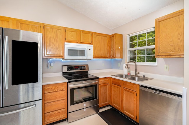 876 Virginiabradford Ct, Erlanger, KY 41018 - kitchen with stainless steel appliances, a sink, vaulted ceiling, light countertops, and a textured ceiling