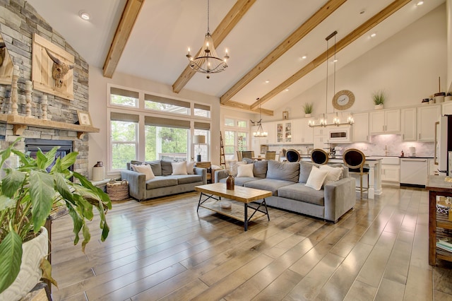 827 Iva Del Ct, Crescent Springs, KY 41017 - living room featuring a chandelier, high vaulted ceiling, a fireplace, beam ceiling, and light wood-type flooring