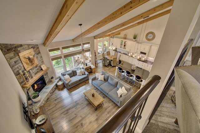 827 Iva Del Ct, Crescent Springs, KY 41017 - living area featuring a chandelier, a glass covered fireplace, wood finished floors, and beam ceiling