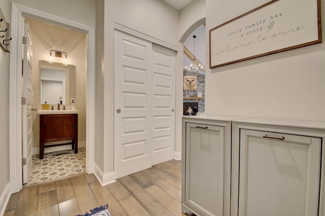 827 Iva Del Ct, Crescent Springs, KY 41017 - hallway with light wood-style flooring and arched walkways