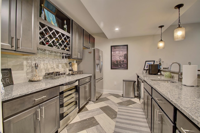 827 Iva Del Ct, Crescent Springs, KY 41017 - kitchen with beverage cooler, a sink, backsplash, stainless steel refrigerator with ice dispenser, and baseboards