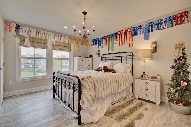 827 Iva Del Ct, Crescent Springs, KY 41017 - bedroom with baseboards, light wood-type flooring, and a chandelier