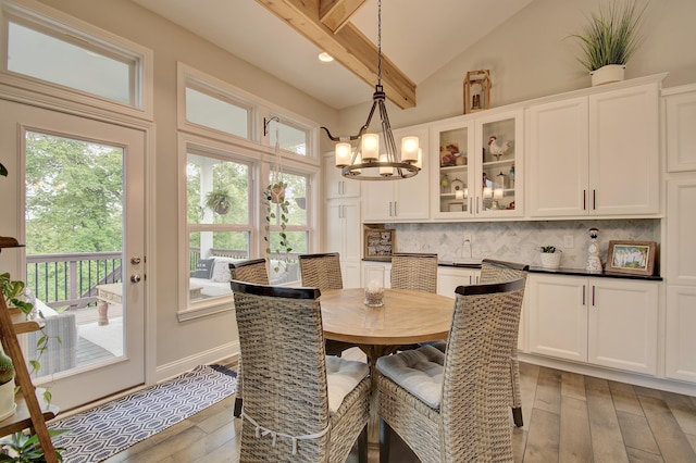 827 Iva Del Ct, Crescent Springs, KY 41017 - dining area featuring wood-type flooring, a chandelier, beam ceiling, and high vaulted ceiling