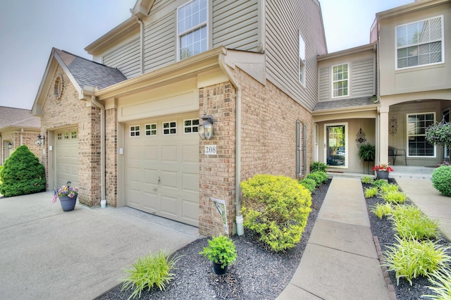 208 Misty Cove Way, Highland Heights, KY 41076 - view of side of home with driveway, brick siding, roof with shingles, and a garage