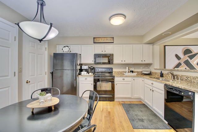 208 Misty Cove Way, Highland Heights, KY 41076 - kitchen featuring black appliances, light wood-style floors, white cabinets, a textured ceiling, and light stone countertops