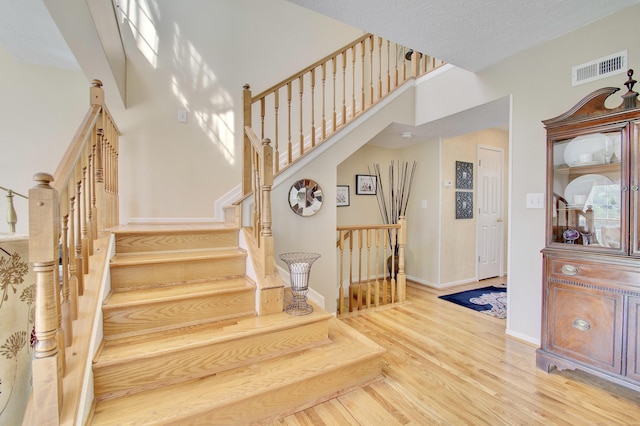 208 Misty Cove Way, Highland Heights, KY 41076 - staircase with wood finished floors and a towering ceiling