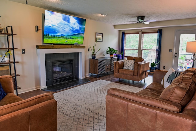 1496 Skye Dr, Independence, KY 41051 - living area featuring a textured ceiling, a tile fireplace, baseboards, a ceiling fan, and wood finished floors