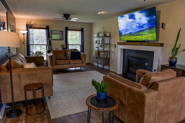 1496 Skye Dr, Independence, KY 41051 - living room featuring wood finished floors, a ceiling fan, a tile fireplace, and a textured ceiling