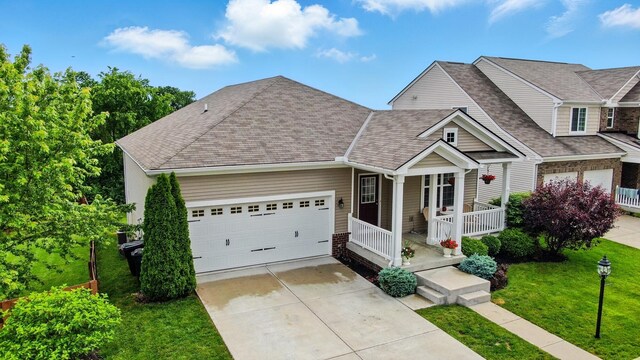 1344 Wilshire Ct, Union, KY 41091 - view of front of property featuring covered porch, a shingled roof, concrete driveway, a front lawn, and an attached garage