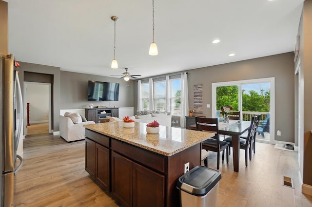 1344 Wilshire Ct, Union, KY 41091 - kitchen with freestanding refrigerator, light wood-style flooring, dark brown cabinets, hanging light fixtures, and recessed lighting