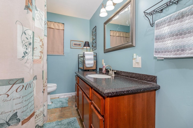 10 Juarez Cir, Covington, KY 41017 - full bath featuring vanity, toilet, baseboards, and stone finish flooring