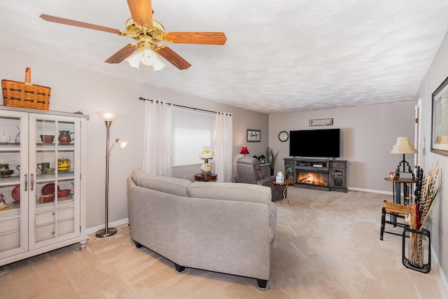 10 Juarez Cir, Covington, KY 41017 - living room with light carpet, ceiling fan, a lit fireplace, and baseboards