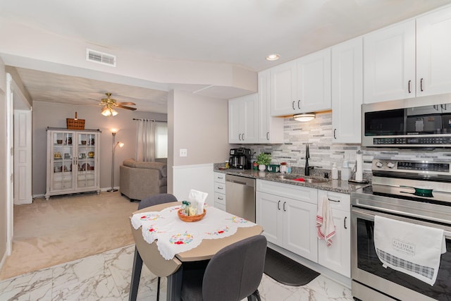 10 Juarez Cir, Covington, KY 41017 - kitchen featuring appliances with stainless steel finishes, a sink, light marble finish floors, white cabinetry, and recessed lighting