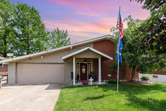 10 Juarez Cir, Covington, KY 41017 - view of front of property with concrete driveway, a front lawn, an attached garage, and brick siding