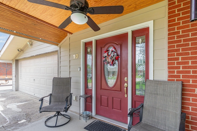 10 Juarez Cir, Covington, KY 41017 - view of exterior entry featuring a garage, ceiling fan, and brick siding