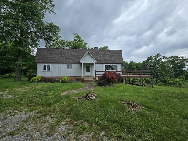 438 Ky Highway 455, Sparta, KY 41086 - view of front of home featuring a chimney, roof with shingles, a front yard, and a wooden deck