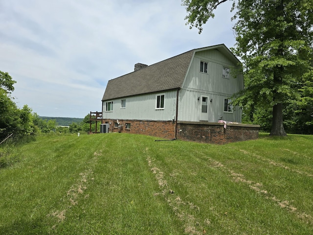 438 Ky Highway 455, Sparta, KY 41086 - view of side of home with a chimney, central air condition unit, a gambrel roof, a shingled roof, and a yard