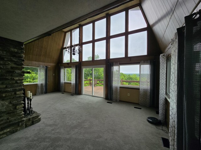 438 Ky Highway 455, Sparta, KY 41086 - unfurnished living room with high vaulted ceiling, carpet, plenty of natural light, and wooden walls